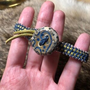 Knitted blue and yellow button bracelet